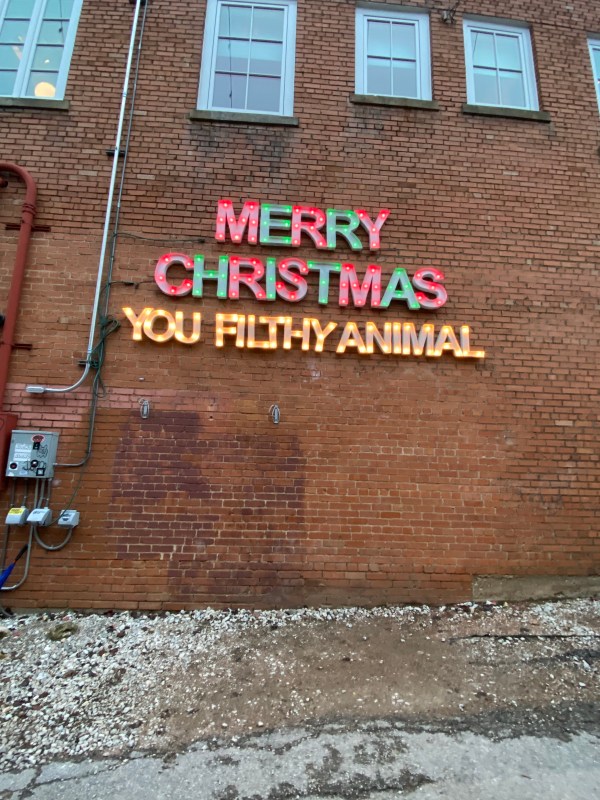 The seasonal "Merry Christmas Ya Filthy Animal" mural wall in Bishop Arts