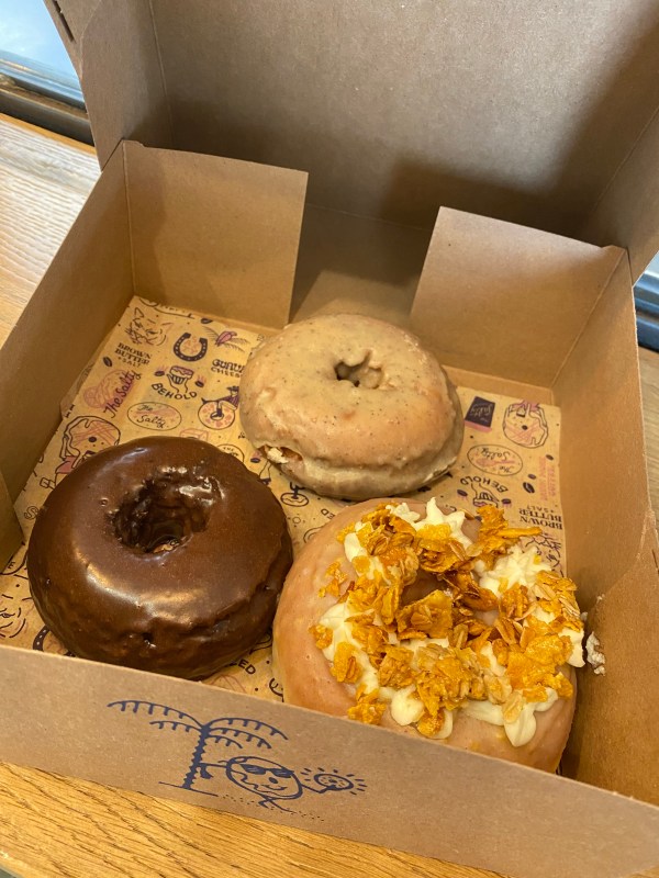 Three delicious donuts in their cute box at The Salty in Bishop Arts, TX
